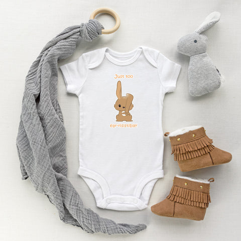 White baby bodysuit with a cute rabbit holding its ear drawing in the kawaii art style with the saying Just Too Ear-risistible! for 2023 Year of the Rabbit. Designed and printed by Bare It Designs.
