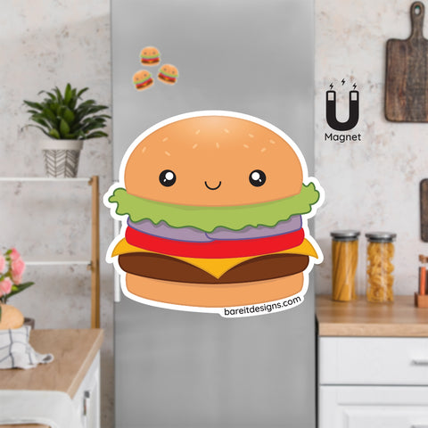 Product picture of a cute flexible cheeseburger  fridge magnet with a background example of cheeseburger magnets clinging to a stainless steel fridge. Cheeseburger magnet is designed by Bare It Designs.