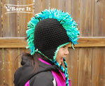 Model is wearing size M punk rocker character crochet toque with ear flaps and braided draw strings. Handmade by Bare It Designs Ltd.