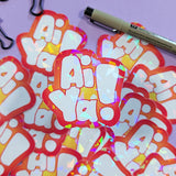 Close up of hologram decorative embellishment vinyl sticker of the Cantonese saying Ai Ya!  Sticker fonts are hand drawn in a balloon (bubble) font style and printed by Bare It Designs, Edmonton, Canada.