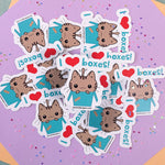 Cute kawaii cat I Heart Boxes! fridge magnet designed by Bare It Designs from Edmonton, AB, Canada. Multiple cat I heart boxes! magnets in a pile with one cat magnet highlighted in the center of the pile.
