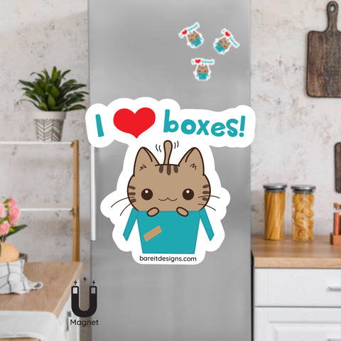 Product picture of a cute brown striped cat popping its head and front paws out of a box with the saying I Heart Boxes! fridge magnet with a background example of the cat magnets clinging to a stainless steel fridge. This cat I heart boxes magnet is designed by Bare It Designs, Edmonton, AB, Canada.