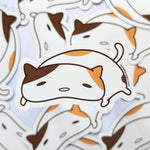 Close up of the cute kawaii lazy cat fridge magnet designed by Bare It Designs from Edmonton, AB, Canada.
