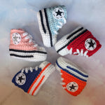 Crochet baby converse sneakers booties handmade by Bare It Designs Ltd. Starting from the top and going clockwise the colours available are: baby blue, red, Edmonton Oilers orange, Edmonton Oilers blue, and baby pink.