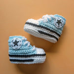 Crochet baby booties in the Converse shoe style in baby blue.  Handmade by Bare It Designs Ltd.