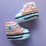 Crochet baby booties in the Converse shoe style in baby pink. Handmade by Bare It Designs Ltd.