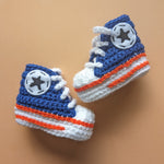 Crochet baby booties in the Converse shoe style in Edmonton Oilers blue. Handmade by Bare It Designs Ltd.