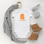 White baby bodysuit with a cute little chicken nugget drawing in the kawaii art style with the saying Little Nugget. Designed and printed by Bare It Designs.