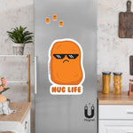 Product picture of a cute chicken nugget wearing thug shades with the saying "Nug Life" fridge magnet.  In the background of the picture shoes Nug Life magnets clinging to a stainless steel fridge. This magnet is designed by Bare It Designs, Edmonton, AB, Canada