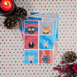 Printed water resistant vinyl sticker sheets of cute kawaii woodland animals holding presents (starting top left: owl, fox, skunk, rabbit, bear, raccoon) gift tags with wintery bright color backgrounds by Bare It Designs, Edmonton, Canada.