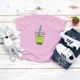 Light pink toddler t-shirt with a cute avocado bubble tea drink drawing in the kawaii art style. Designed and printed by Bare It Designs.