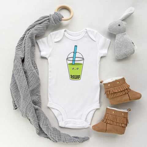 White baby bodysuit with an avocado bubble tea drink with a cute face kawaii art style designed and printed by Bare It Designs.