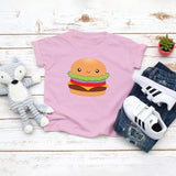 Light pink toddler t-shirt with a cute cheeseburger with all the toppings drawing in the kawaii art style. Designed and printed by Bare It Designs.