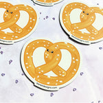Close up of a cute kawaii pretzel twist fridge magnet designed by Bare It Designs from Edmonton, AB, Canada.