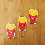 Cute kawaii fries fridge magnet designed by Bare It Designs from Edmonton, AB, Canada. Three fries magnets arranged in an ascending diagonal line.