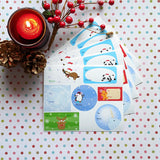Printed water resistant vinyl sticker sheets of Christmas holiday gift tags with wintery backgrounds, kawaii animals and associated winter items by Bare It Designs, Edmonton, Canada. 