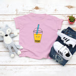 Light pink toddler t-shirt with a cute mango bubble tea drink drawing in the kawaii art style. Designed and printed by Bare It Designs.