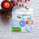 Package of printed water resistant vinyl sticker sheets of Christmas holiday gift tags with wintery backgrounds, kawaii animals and associated winter items by Bare It Designs, Edmonton, Canada.