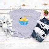 Grey toddler t-shirt with a cute happy ramen noodle bowl drawing in the kawaii art style. Designed and printed by Bare It Designs.