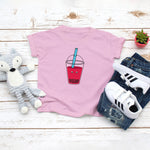 Light pink toddler t-shirt with a cute strawberry bubble tea drink drawing in the kawaii art style. Designed and printed by Bare It Designs.